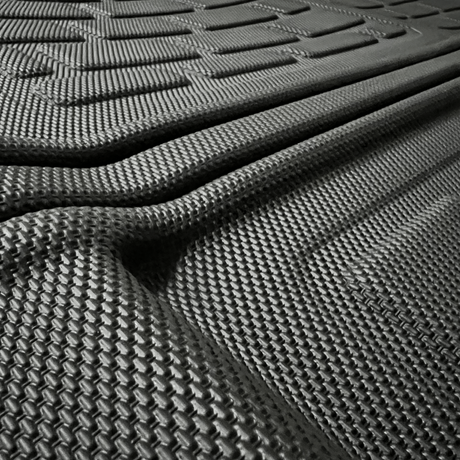 Close-up van een zwarte automatten met getextureerde groeven.