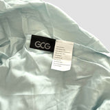 Lichtblauw GCG MAX bamboe hoeslaken met labels die wasinstructies en productinformatie tonen.